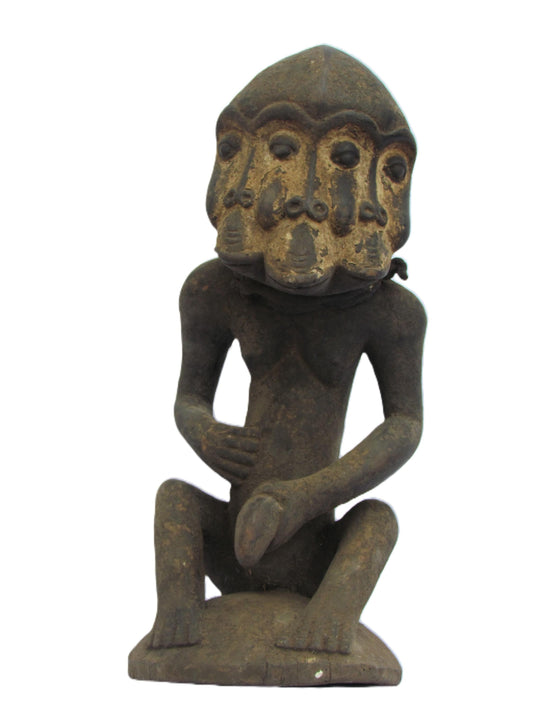 Figure masculine Luba Songo assise tenant un organe génital élu à trois visages, République démocratique du Congo et Zambie.